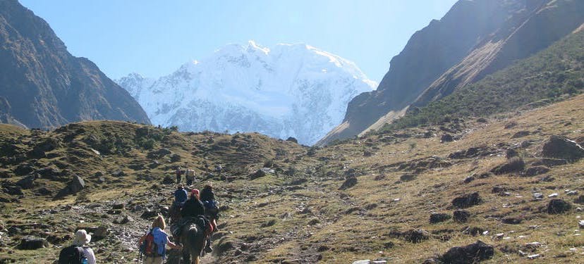 So much land lay ahead, it's beautiful, but can become daunting if you aren't used to this kind of adventure. Best Hikes In Peru Image: A group of hikers is pictured making their long trek—there is so much land ahead of them.