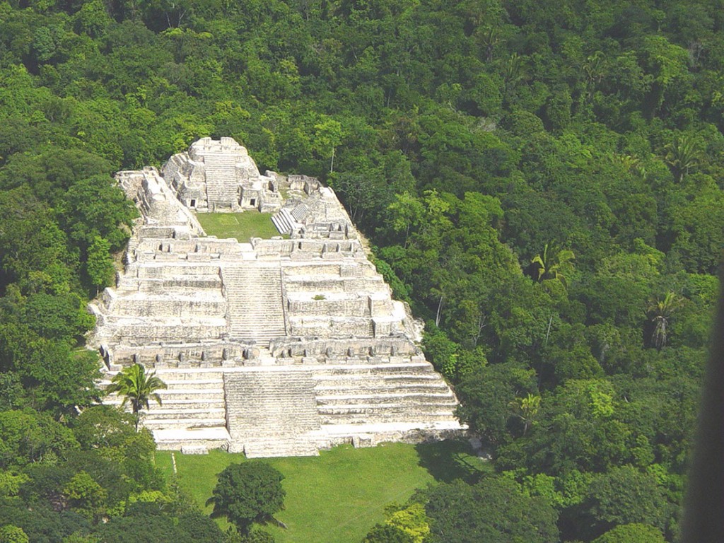 Central and South American Ruins Image: An aerial view of one of the ancient city's prominent structures. It appears to be placed in the middle of the jungle, apart from some of the other city structures.