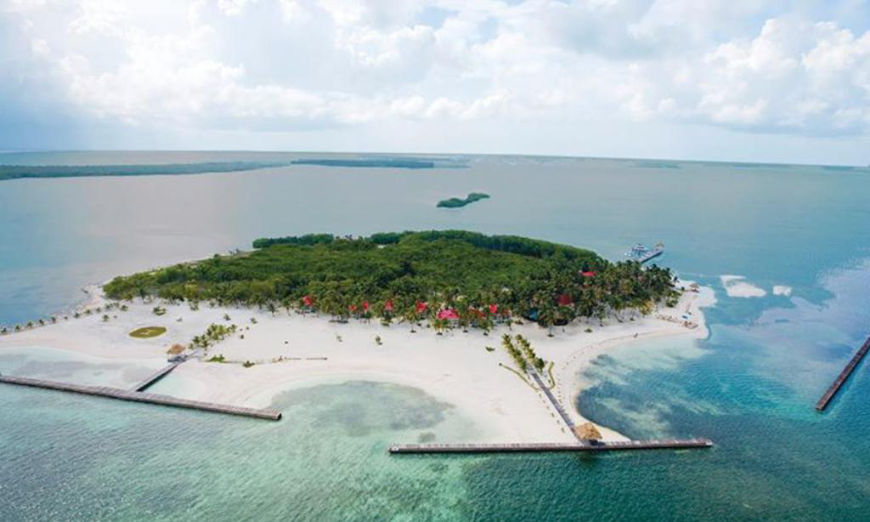 Best Beaches for Swimming in Belize Image: An Aerial view of Turneffe, showing docks, sand, and a lush, central green space.