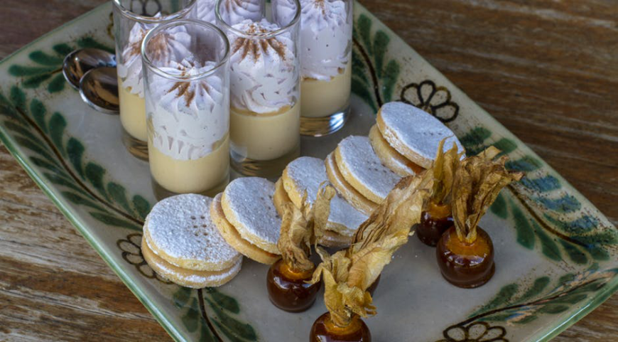 Eat an especially good dish? Try to learn the recipe, and recreate part of your vacation whenever you want! Best Travel Stories Image: A decadent tray of Peruvian desserts including a parfait in a glass, biscuits/cookies, and a treat dipped in chocolate.