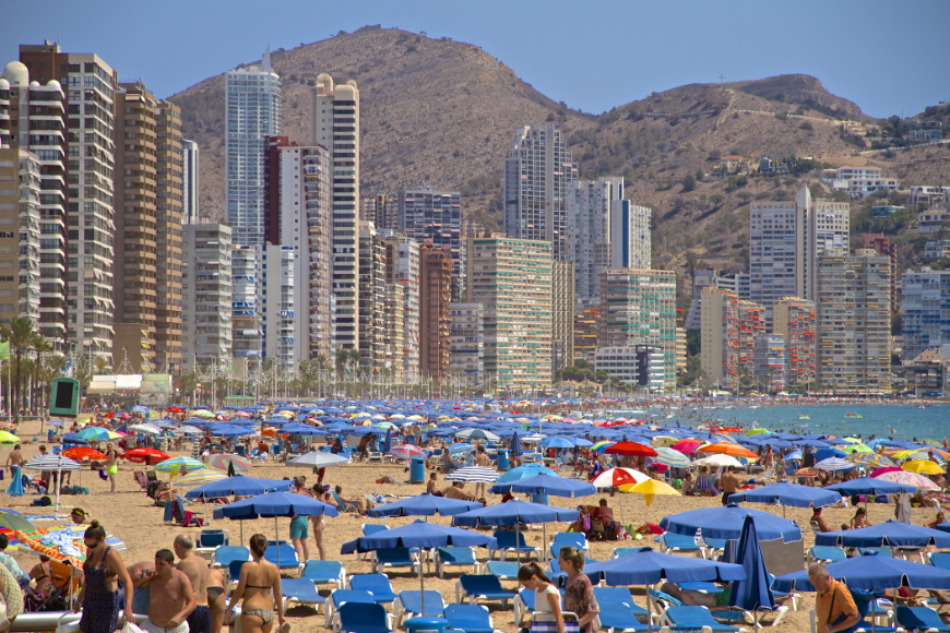 Ever buy clothes online and receive apparel that looks nothing like the photo? This is the holiday version of that! Best Travel Stories Image: A beach is crowded by tourists, their lounge chairs, and beach umbrellas. Skyscrapers block most of the landscape.