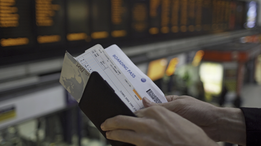You won't forget to print out your itinerary when you book with Anywhere, because we send you a reminder! Booking A Vacation Online Image: A person's hands are examining an itinerary, ticket, and boarding pass.