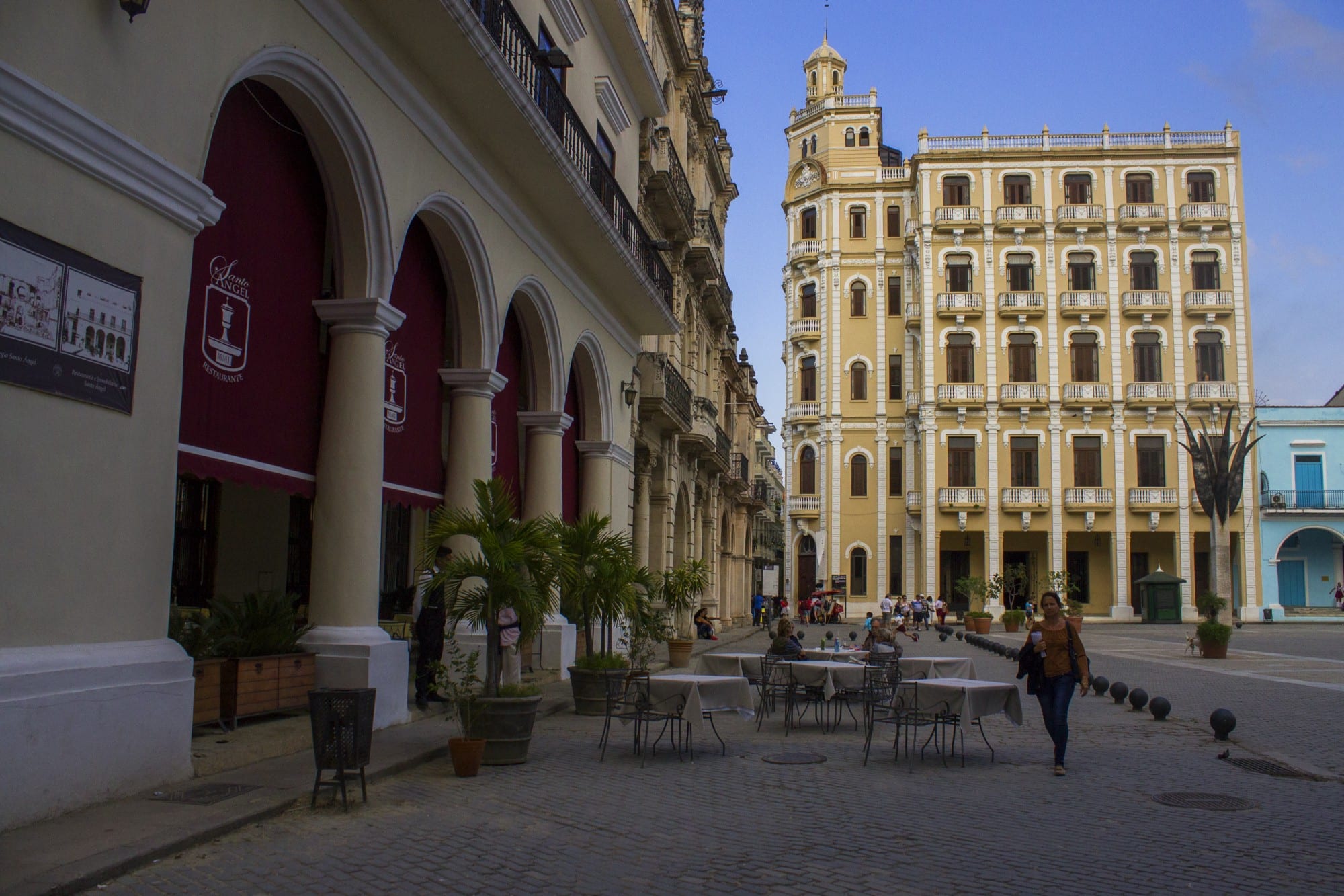 Oddly enough, the buildings seen here are decidedly traditional, not modern. Cuba Unusual Museum Image: We see two pale lemon buildings with white accents and arches: the structures are decidedly traditional, not modern.