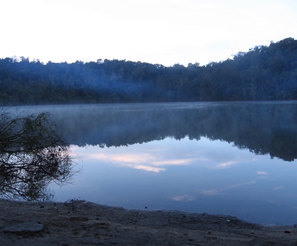 Nature reflected in one of nature's very own features. If you pause, it really makes you think. Mystical Destinations Image: The surrounding trees and sky are visible and reflected in the waters of the lagoon.