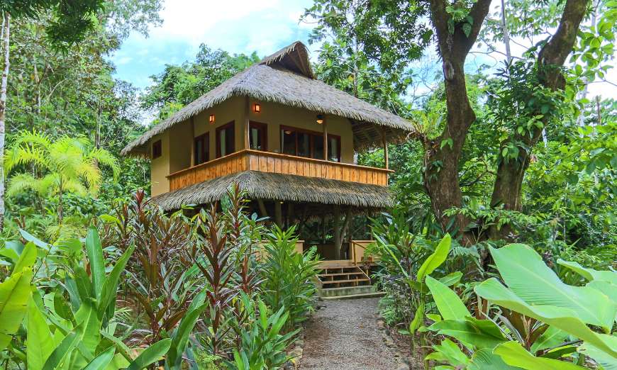 Eco-resort bonus? They tend to be secluded ;-) Eco-Friendly Destination Wedding Image: Exterior of Copa del Árbol. A wraparound balcony and thatched roof building sits in the midst of a forest.