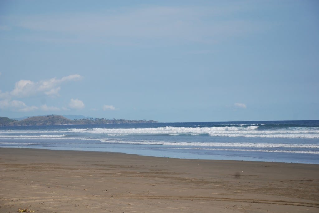 Best Surfing Beaches: The beach is empty, and waves are cresting highly as they roll in.