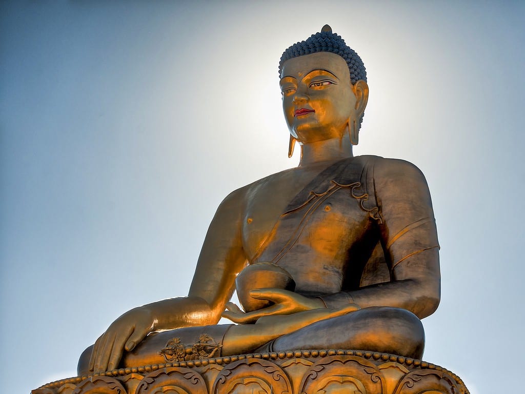 Destinations Worth Dreaming Image: The golden Buddha Dordenma statue has a slight smile, and holds a bowl.