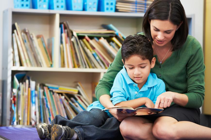 The Imagination Bus is a reminder that story time makes for great family time. Imagination Bus Image: A mother or teacher sits and reads with a young boy.