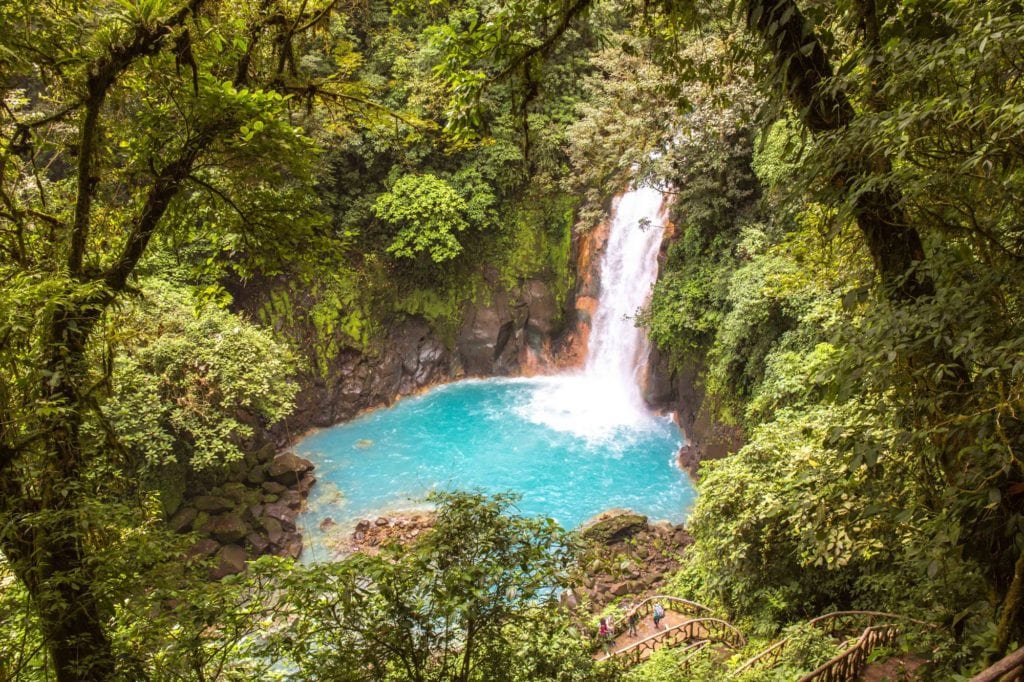 It's hard to top nature's swimming pools. Best Vacation Ever Image: A waterfall in the midst of a jungle gloriously empties itself into crater of turquoise water below.