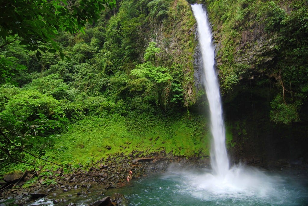Swimming Holes Image: La Fortuna Waterfall cascades into the swimming hole beneath it.