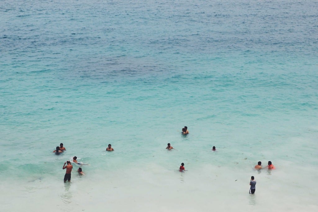 Destinations Worth Dreaming Image: People are swimming and playing in Mexico's warm blue ocean waters.