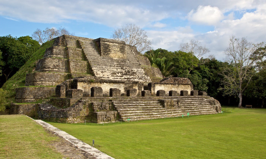 Moving to Belize Image: A Mayan pyramid sits in a forest clearing.