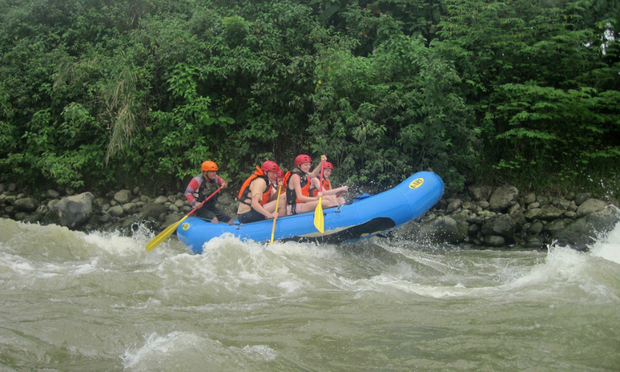 Talk about rushing over rapids! Moving to Panama Image: A group of people are partially lifted up over big rapids.