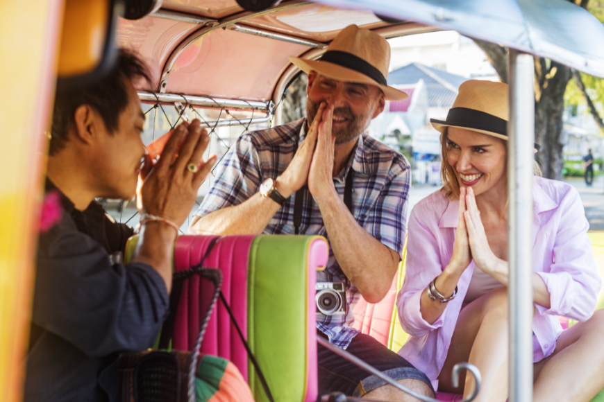 It should go without saying, but be respectful of people and sacred spaces whilst abroad. Sustainable Travel Practices Image: A tuktuk driver shows a couple a proper greeting—in this case, prayer hands.