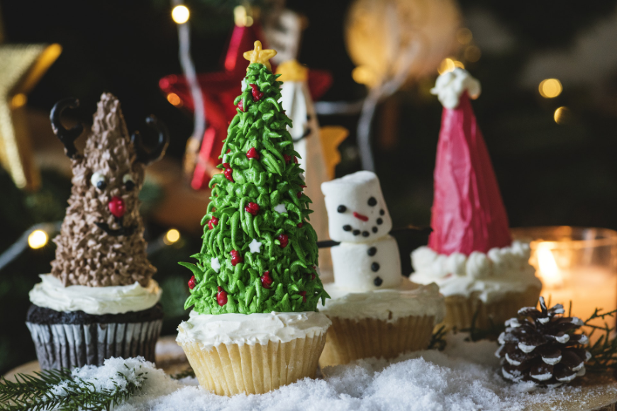 Tropical Holiday Image: Cupcakes decorated as a reindeer, Christmas tree, snow man, and Santa hat.