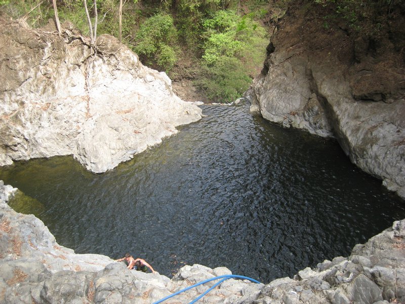 A deep, dark pool between pale rock walls at the Montezuma waterfalls