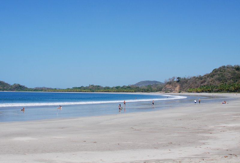 Swimmers in the calm, shallow water of Playa Carrillo
